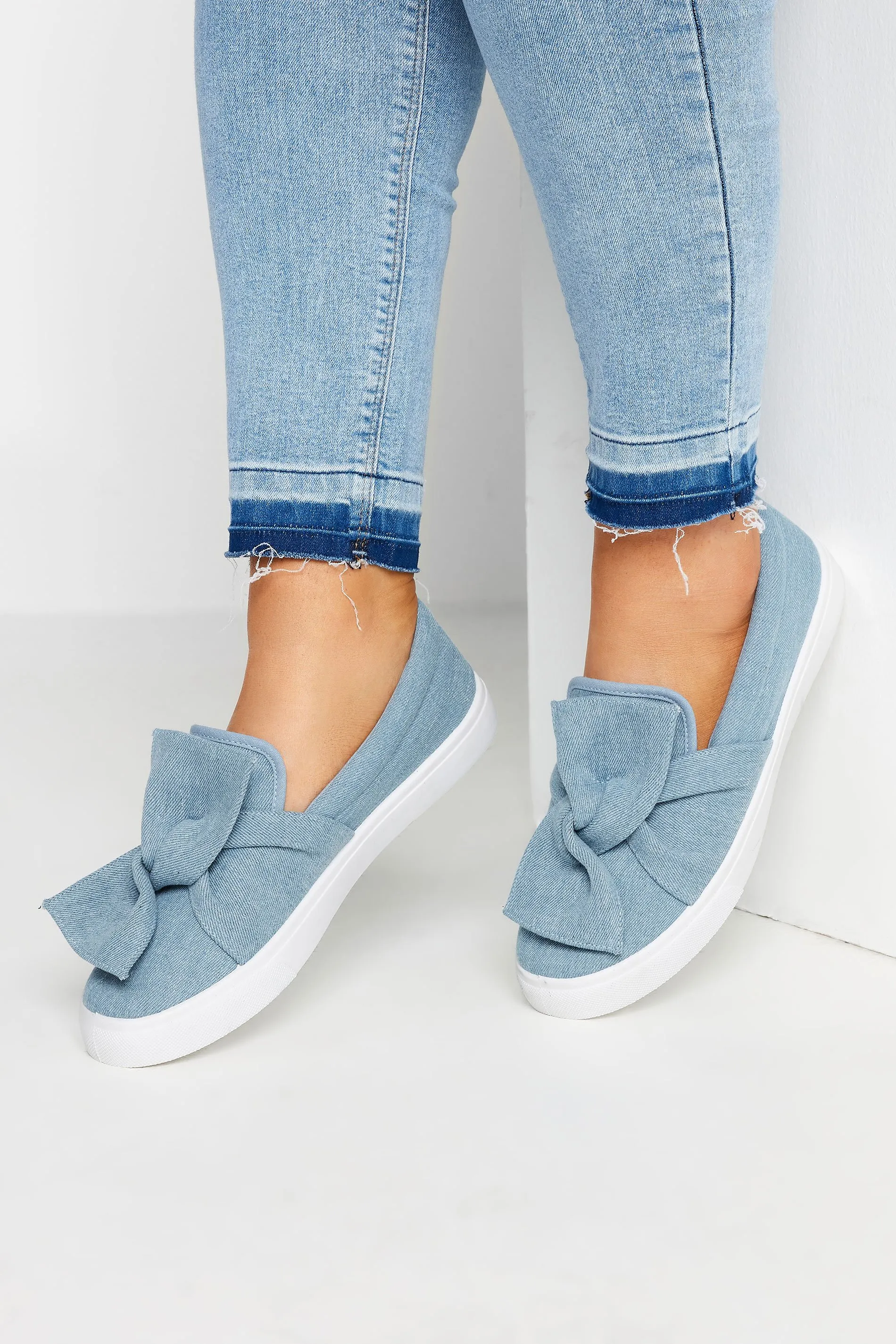 Blue Denim Twisted Bow Slip-On Trainers In Wide E Fit