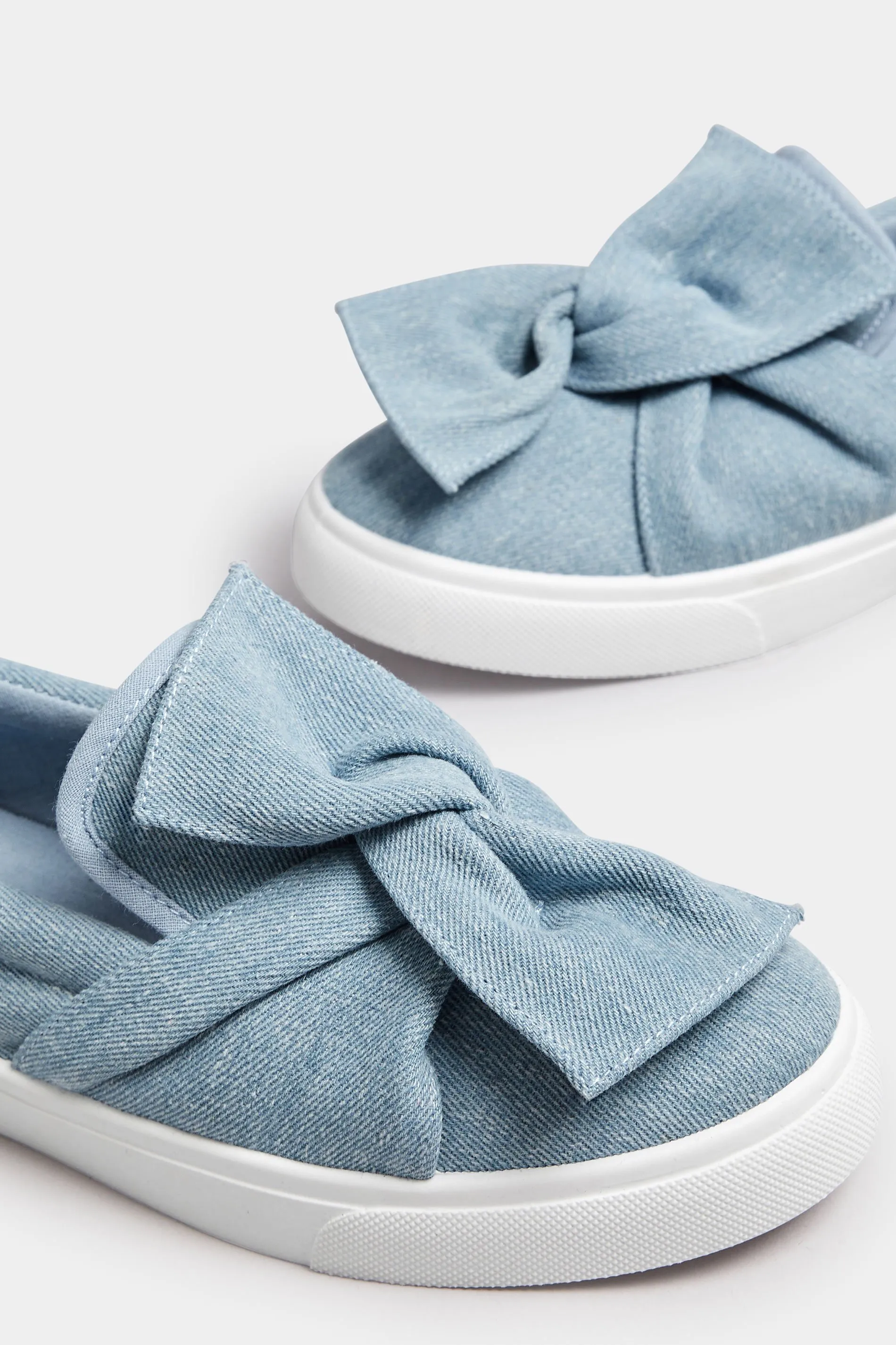 Blue Denim Twisted Bow Slip-On Trainers In Wide E Fit